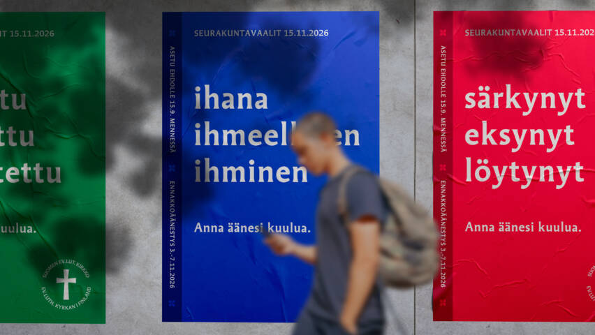 Nuori kävelee kadulla vaalijulisteiden ohi